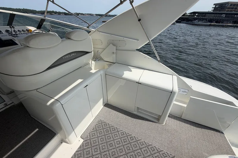 Slide: The Image of Luxury interior of 1997 Trojan 440 Express yacht with seating and water view. - 12