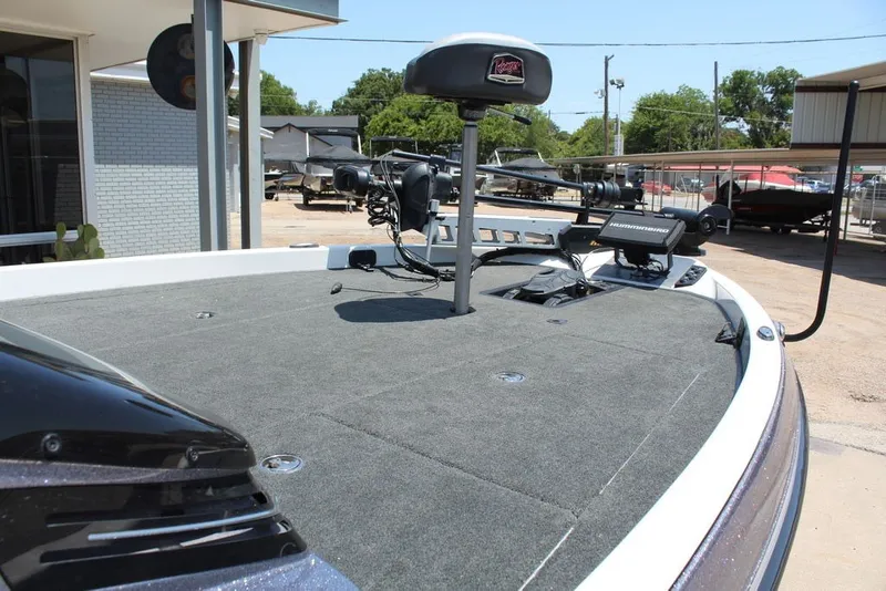 Slide: The Image of 2017 Ranger Z519 boat deck with fishing equipment and electronics in a marina setting. - 20