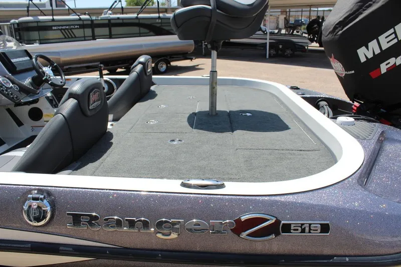 Slide: The Image of 2017 Ranger Z519 boat interior with seating and steering wheel, showcasing spacious deck design. - 22