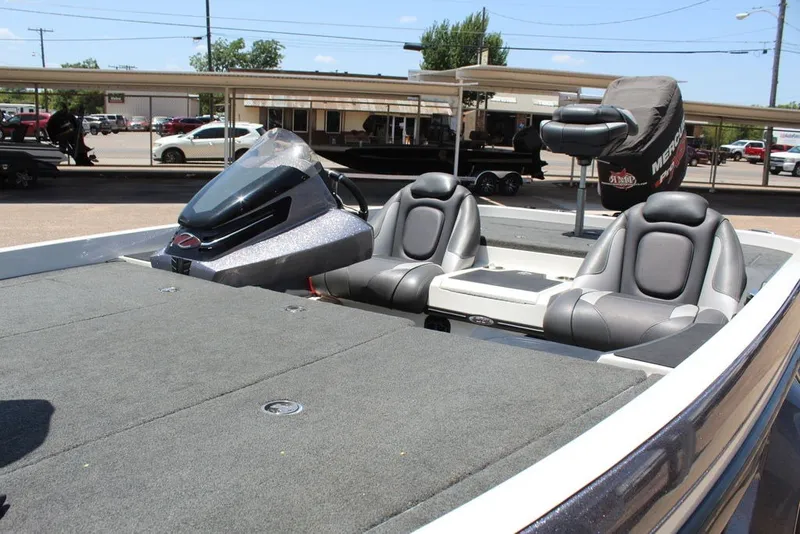 Slide: The Image of 2017 Ranger Z519 boat interior with dual seats and console, parked outdoors. - 14