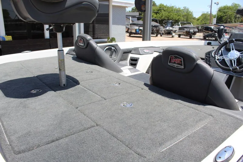 Slide: The Image of 2017 Ranger Z519 boat interior with gray carpet and seating, showcasing steering wheel and controls. - 16