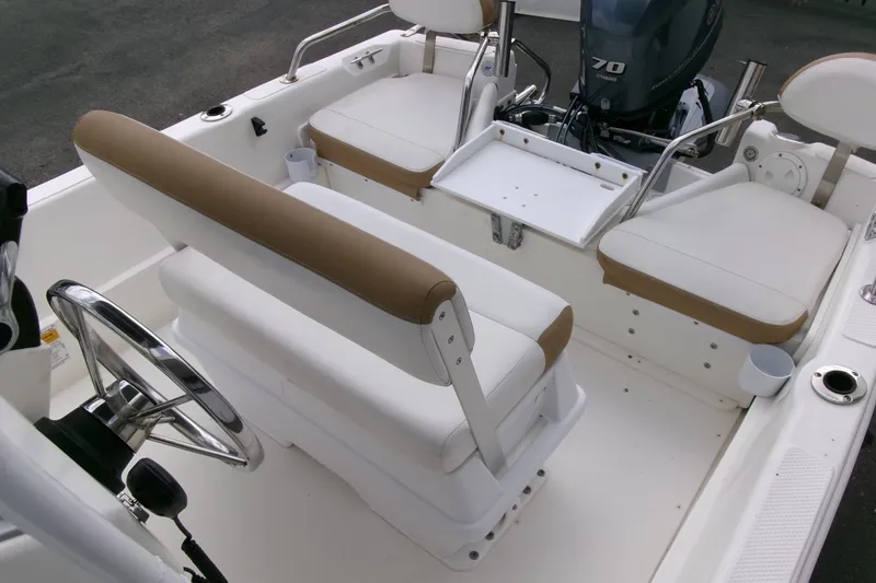 Slide: The Image of Interior of a 2014 Triumph 170 CC boat with seating and steering wheel. - 14