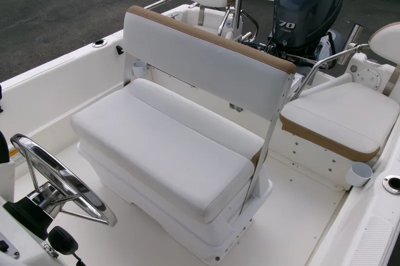 Slide: The Image of Interior of a 2014 Triumph 170 CC boat with white seating and steering wheel. - 13