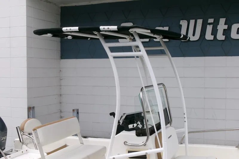 Slide: The Image of 2014 Triumph 170 CC boat with T-top and seating, displayed outdoors. - 19