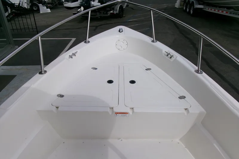 Slide: The Image of Bow view of a 2014 Triumph 170 CC boat with storage compartments. - 4