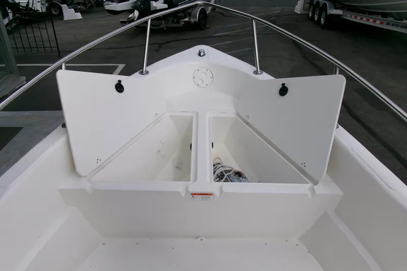 Slide: The Image of 2014 Triumph 170 CC boat interior with open storage compartments. - 5