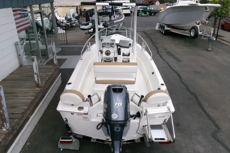 Slide: The Image of 2014 Triumph 170 CC boat with Yamaha 70 engine, parked at a dealership. - 24