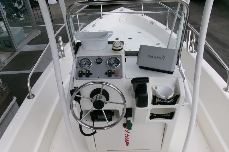 Slide: The Image of 2014 Triumph 170 CC boat dashboard with Garmin navigation system and steering wheel. - 9
