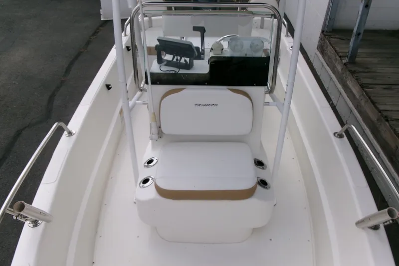 Slide: The Image of 2014 Triumph 170 CC boat interior with steering console and seating. - 6