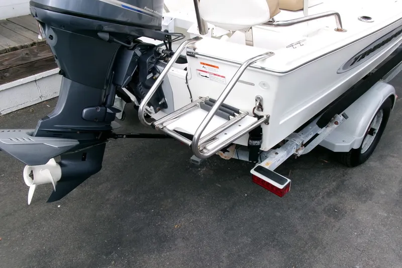 Slide: The Image of 2014 Triumph 170 CC boat with outboard motor and trailer. - 20
