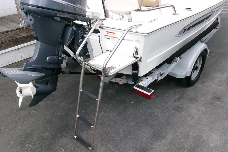 Slide: The Image of 2014 Triumph 170 CC boat with outboard motor and ladder on trailer. - 21