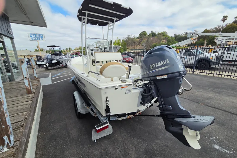 Slide: The Image of 2014 Triumph 170 CC boat with Yamaha outboard motor, parked at a dealership. - 3