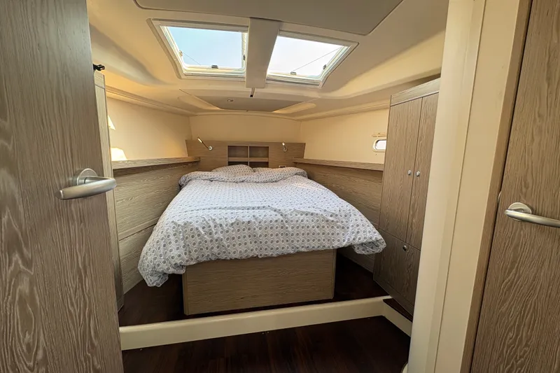 Slide: The Image of Cozy cabin interior of 2018 Hanse 455 yacht with skylight and wooden furnishings. - 25