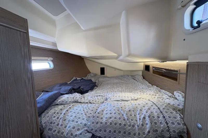 Slide: The Image of Cozy cabin interior of 2018 Hanse 455 yacht with patterned bedding and natural light. - 27