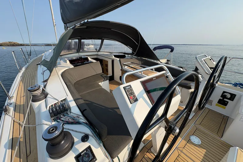 Slide: The Image of 2018 Hanse 455 sailboat cockpit with dual steering wheels and navigation equipment. - 11