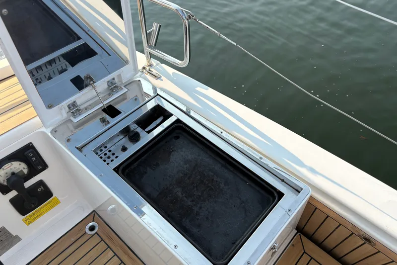 Slide: The Image of A grill on a 2018 Hanse 455 boat, featuring a wooden deck and water in the background. - 18