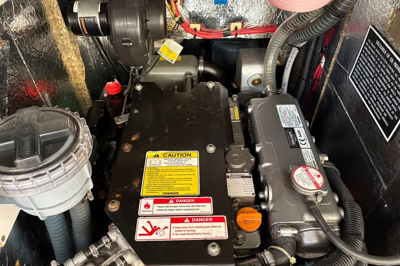 Slide: The Image of Engine compartment of a 2018 Hanse 455 yacht, featuring Yanmar engine components. - 34