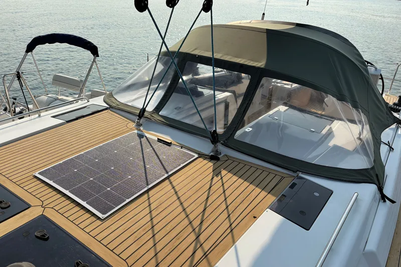 Slide: The Image of 2018 Hanse 455 yacht with solar panel on teak deck, docked by the water. - 12