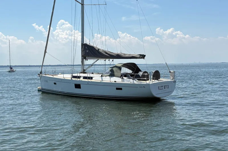 Slide: The Image of 2018 Hanse 455 sailboat on calm water under a clear sky. - 4