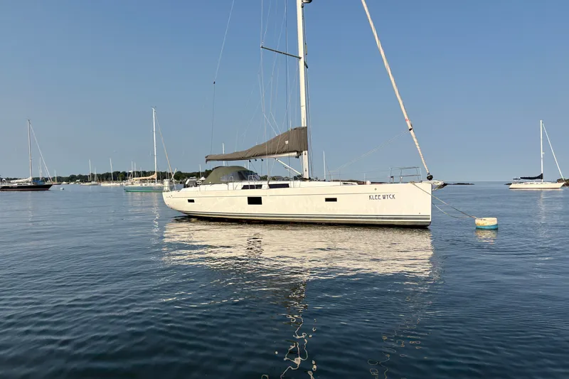 Slide: The Image of Sailing yacht Hanse 455, 2018 model, anchored on calm waters under clear blue sky. - 2