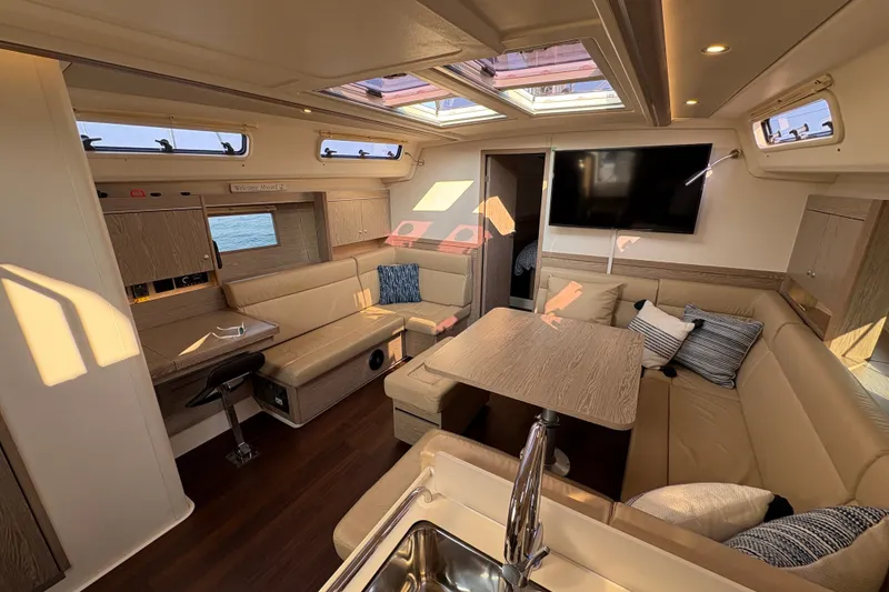 Slide: The Image of Luxurious interior of 2018 Hanse 455 yacht with modern furnishings and ample natural light. - 21