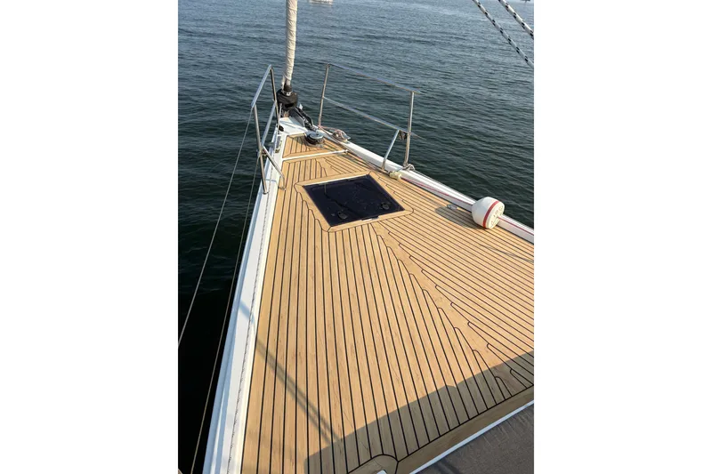 Slide: The Image of 2018 Hanse 455 yacht deck with teak finish on calm water. - 16