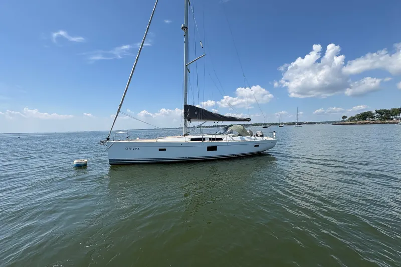 Slide: The Image of Sailing yacht Hanse 455, 2018 model, anchored on calm waters under a clear blue sky. - 3