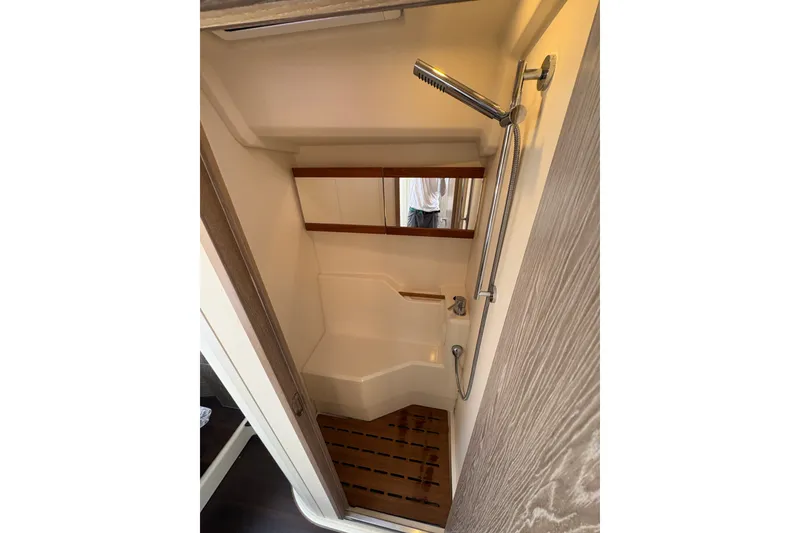 Slide: The Image of Compact shower area in 2018 Hanse 455 yacht with wooden accents and modern fixtures. - 29