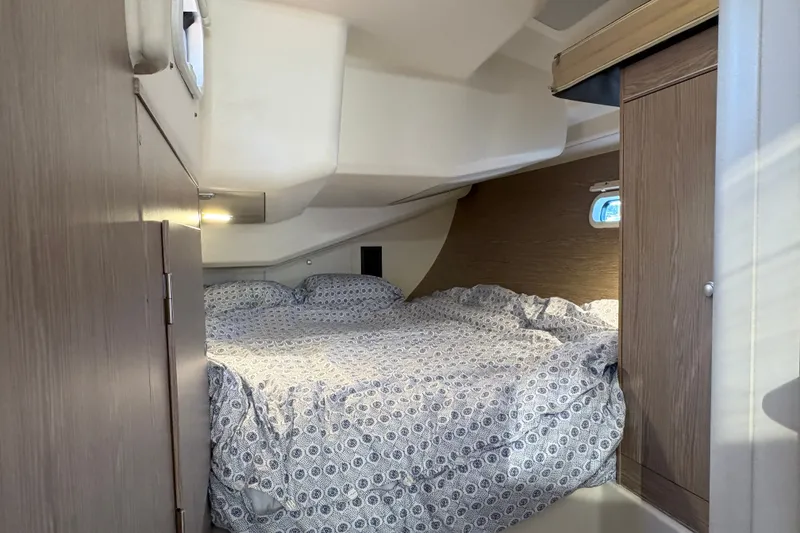 Slide: The Image of Cozy cabin interior of 2018 Hanse 455 yacht with patterned bedding and wooden accents. - 26