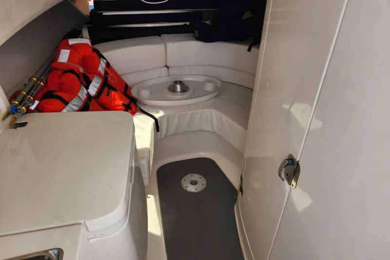 Slide: The Image of Interior of 2003 Intrepid 289 Walkaround boat with seating and life jackets. - 29