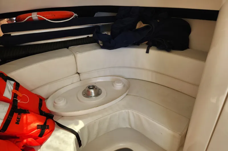 Slide: The Image of Interior of 2003 Intrepid 289 Walkaround boat with seating and life jackets. - 30
