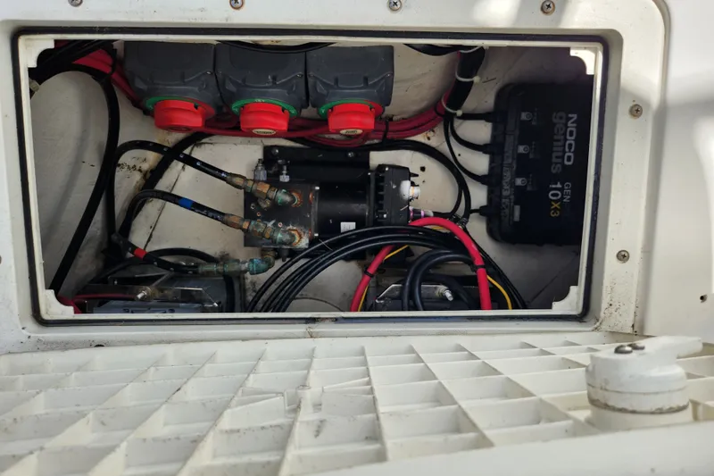 Slide: The Image of Electrical compartment of a 2003 Intrepid 289 Walkaround boat, featuring wiring and battery components. - 46