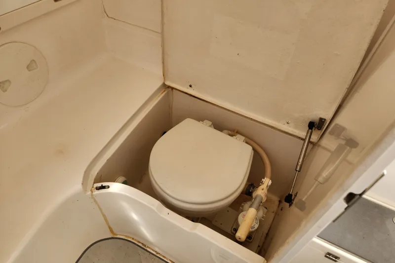 Slide: The Image of 2003 Intrepid 289 Walkaround boat toilet in compact marine bathroom. - 37