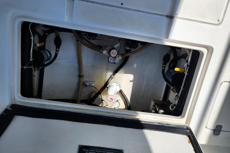 Slide: The Image of Engine compartment of a 2003 Intrepid 289 Walkaround boat, showing hoses and components. - 39