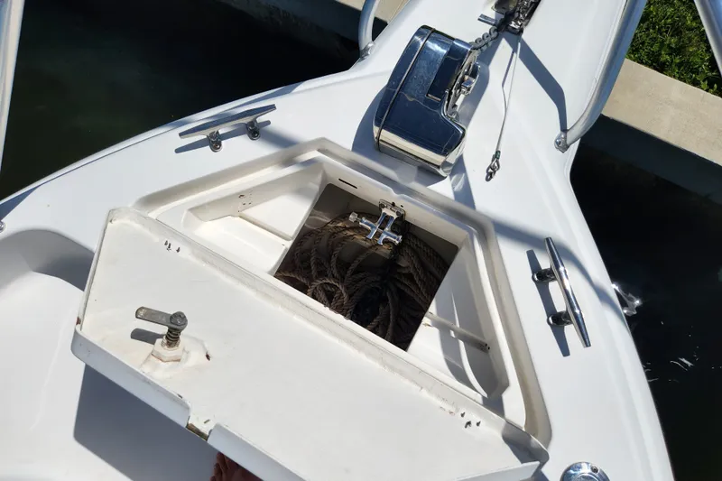 Slide: The Image of Open anchor locker on a 2003 Intrepid 289 Walkaround boat, showing ropes and hardware. - 22
