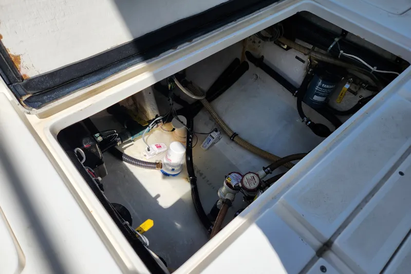 Slide: The Image of Open engine compartment of a 2003 Intrepid 289 Walkaround boat, showing hoses and components. - 40