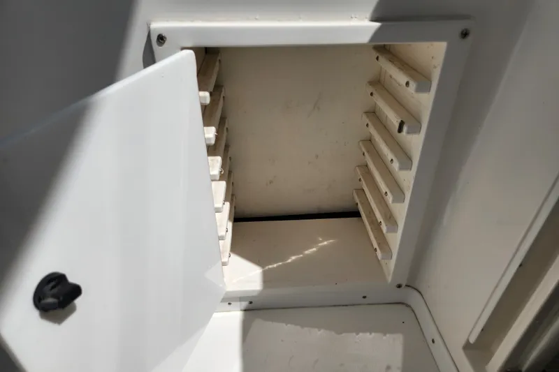 Slide: The Image of Open storage compartment on a 2003 Intrepid 289 Walkaround boat. - 45