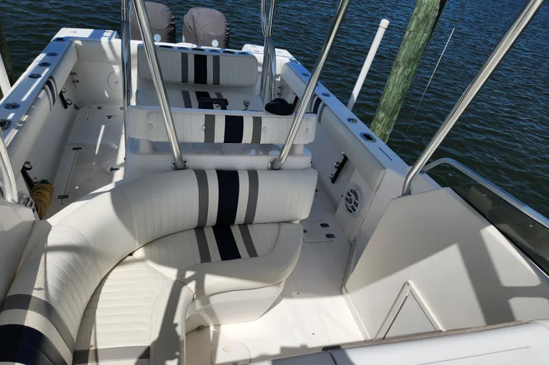 Slide: The Image of 2003 Intrepid 289 Walkaround boat interior with white seating and striped accents. - 24
