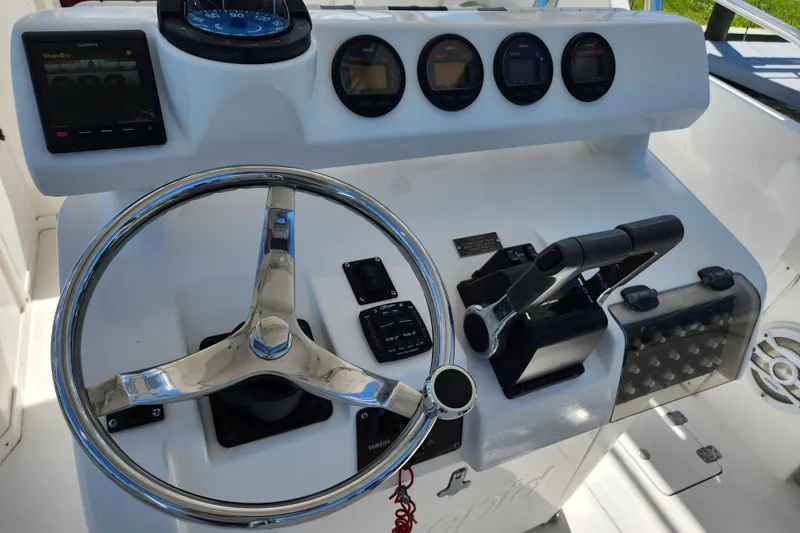 Slide: The Image of 2003 Intrepid 289 Walkaround helm with steering wheel and control panel. - 14
