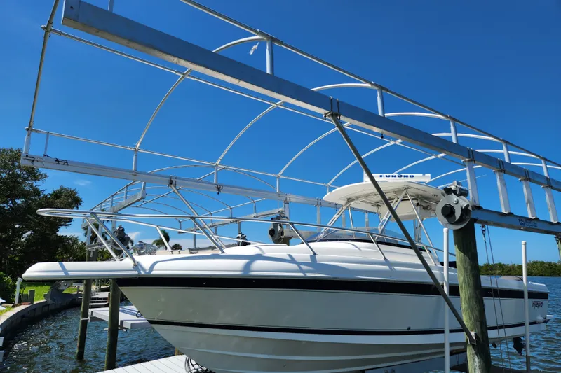 The Image of 2003 Intrepid 289 Walkaround boat docked under a clear blue sky. - 0