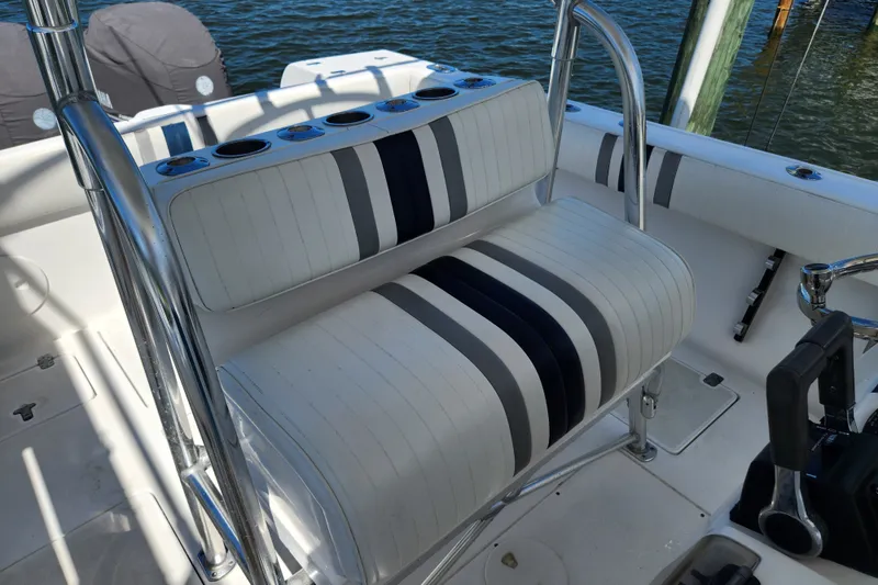 Slide: The Image of 2003 Intrepid 289 Walkaround boat seating with striped upholstery and cup holders. - 16
