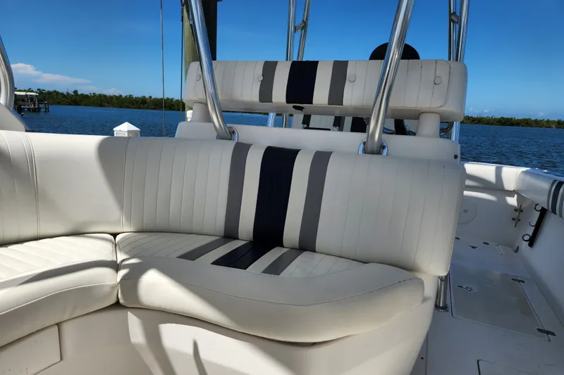 Slide: The Image of 2003 Intrepid 289 Walkaround boat interior with white and black seating, ocean view. - 26