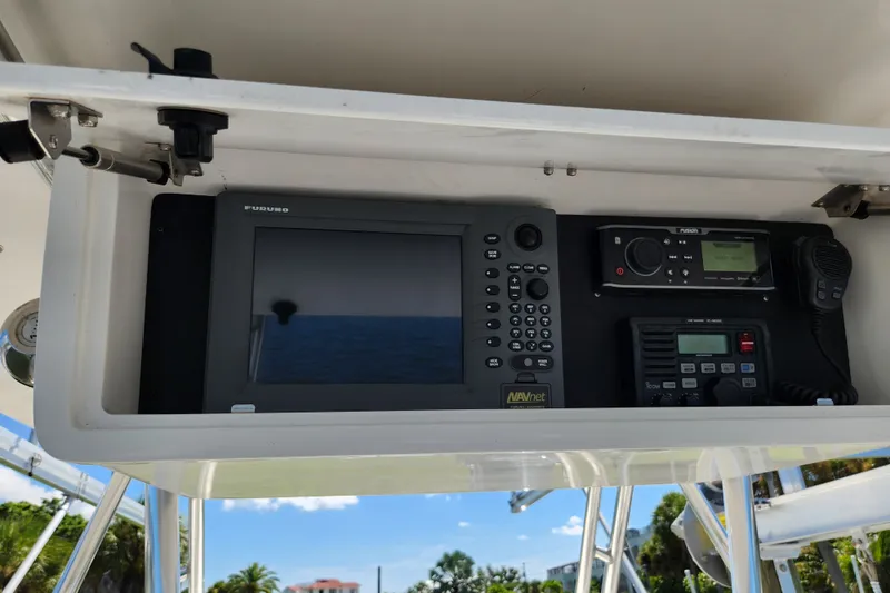 Slide: The Image of 2003 Intrepid 289 Walkaround boat electronics panel with navigation and communication devices. - 19