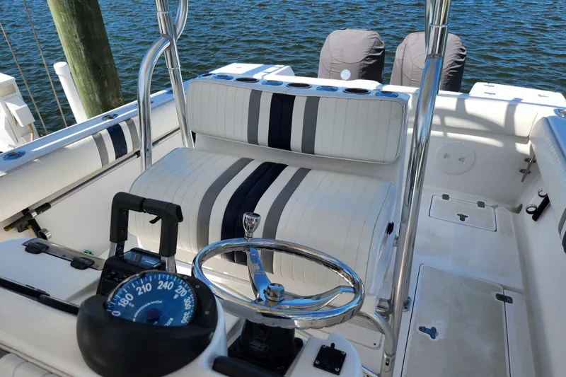 Slide: The Image of 2003 Intrepid 289 Walkaround boat interior with striped seating and steering wheel. - 27