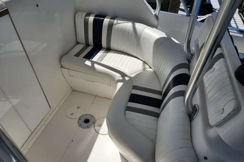 Slide: The Image of 2003 Intrepid 289 Walkaround boat interior with striped seating and stainless steel railings. - 25