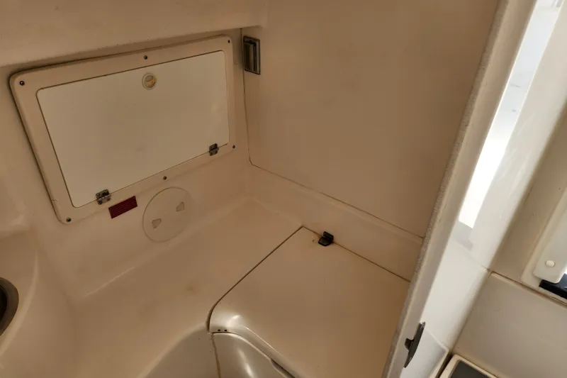 Slide: The Image of Interior of a 2003 Intrepid 289 Walkaround boat, featuring storage compartments. - 36