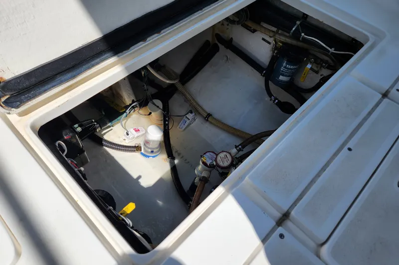 Slide: The Image of Open hatch of a 2003 Intrepid 289 Walkaround boat showing internal components and wiring. - 41