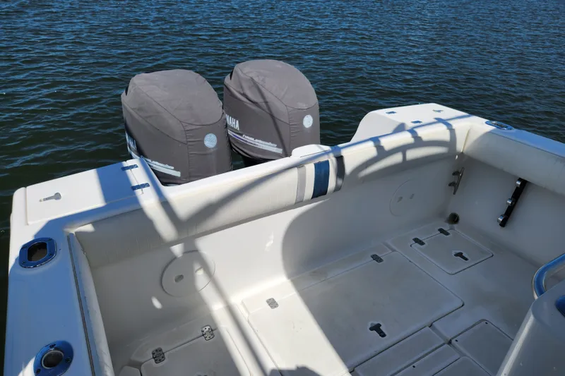 Slide: The Image of 2003 Intrepid 289 Walkaround boat with Yamaha engines, docked on calm water. - 17