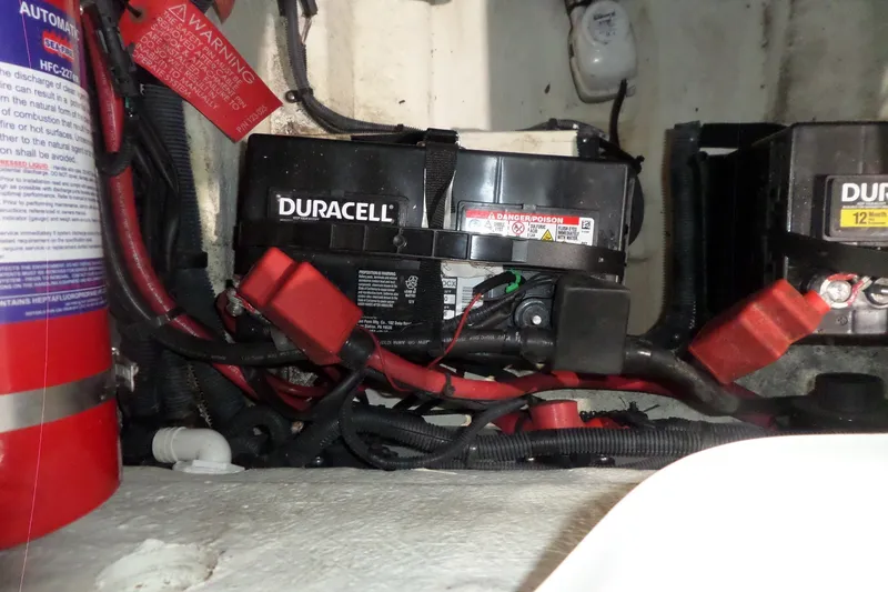 Slide: The Image of Battery compartment of a 2017 Sea Ray SDX 240 with Duracell batteries and wiring. - 51