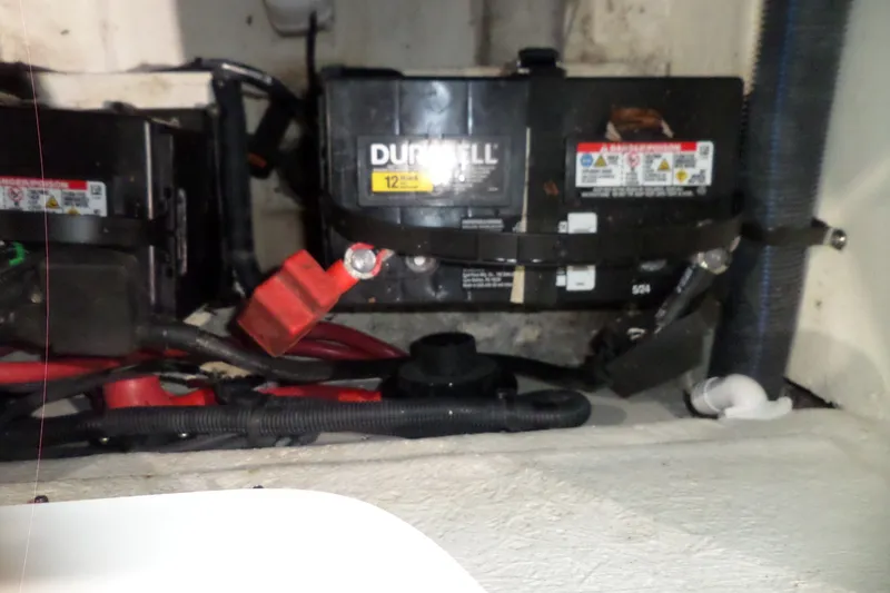 Slide: The Image of Battery compartment of a 2017 Sea Ray SDX 240 boat, featuring Duracell batteries. - 52